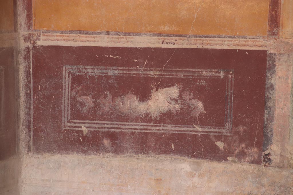 IX.3.5 Pompeii. October 2023. 
Room 13, painted sea-monster and dolphin from predella on lower west wall, in south-west corner. Photo courtesy of Klaus Heese.
