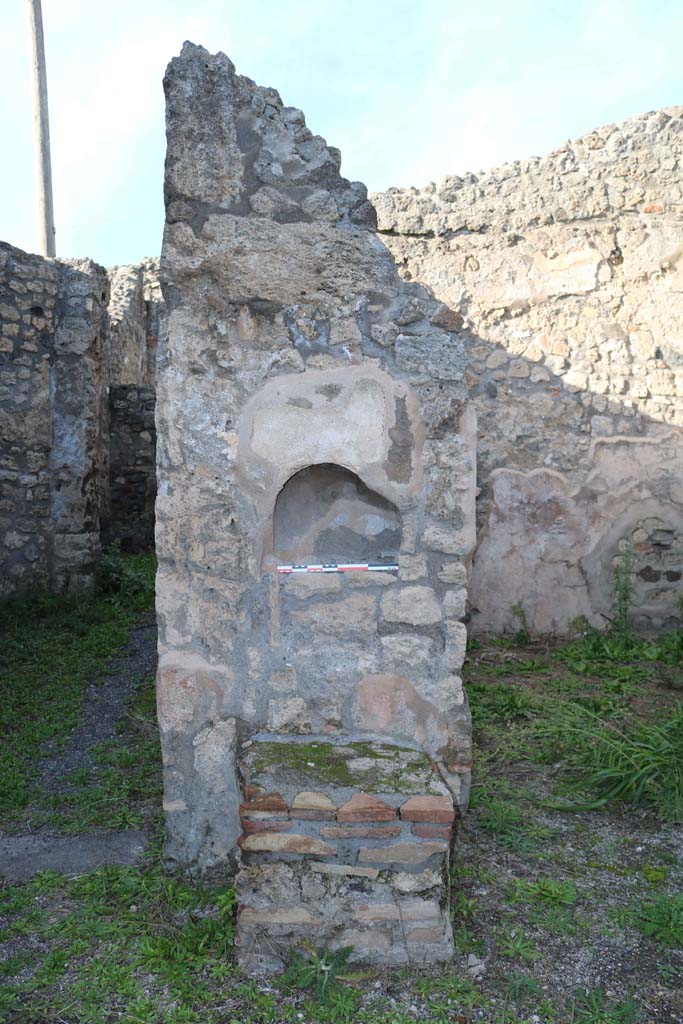IX.3.14 Pompeii. December 2018. Detail of niche, and altar in shop. Photo courtesy of Aude Durand.
According to Boyce –
In the north wall is an arched niche (h.0.30, w.0.43, d.0.18, h. above floor 1.37), and against the wall below it stands a masonry altar (0.62 by 0.55. h.0.62).
See Boyce G. K., 1937. Corpus of the Lararia of Pompeii. Rome: MAAR 14. (p.84, no.413).
