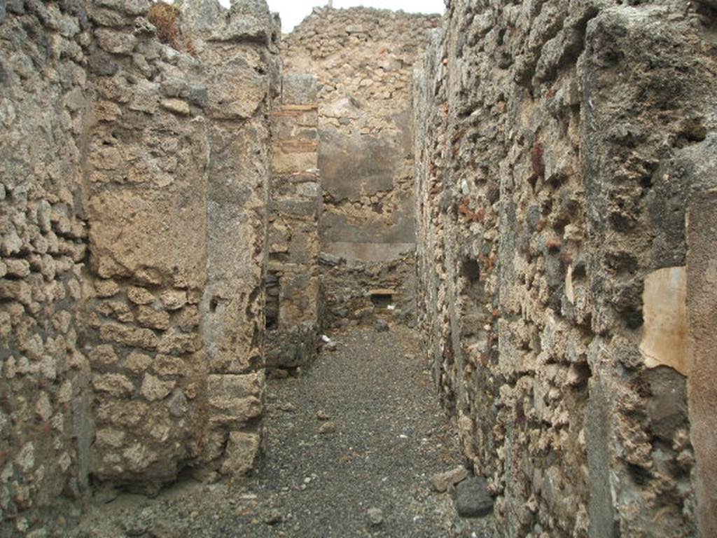 IX.3.14 Pompeii. May 2005. 
Corridor to rear on west side, which was only partly covered by a roof, containing the fusorium, hearth and the latrine.
