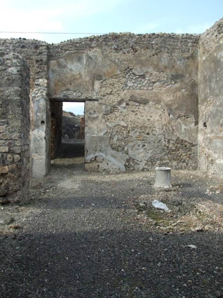 IX.3.15 Pompeii. March 2009. Room 2, atrium, looking northerly towards the doorway to the corridor. Mau described the wall decoration as being a simple scheme. It was of a yellow zoccolo, the middle zone of the walls being white, and a purple/violet frieze.
