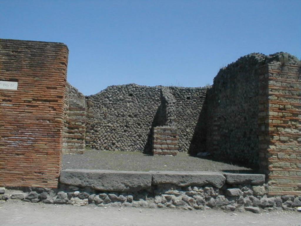 IX.4.1 Pompeii. May 2005. Entrance, looking east from Via Stabiana, towards rear rooms. 
According to Maiuri, three of the shops on the corner of this insula, appear to have had an elevated threshold of at least 0.80m above the floor of the sidewalk and what should have been the original threshold. They clearly distinguish the brickwork/masonry of the above elevation from the original floor of the threshold. In the third taberna (from the corner of the quadrivium) IX.4.3, only one block of the threshold appears located in its place.
See Maiuri, A, (2002): Lultima fase edilizia di Pompei, Arte Tipografica, Naples, (p.75, note 3).
. 