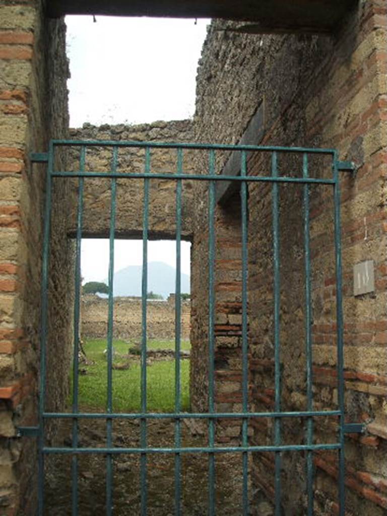 IX.4.10 Pompeii. May 2005. Secondary Entrance on South Side.Looking north along entrance corridor from entrance doorway.
On the right of the corridor is a doorway leading into the multi-seat public latrine e.
According to Hobson, Mau showed a drain from the large swimming tank h in the Central Baths passing to the public latrine, presumably to act as a sluicing system 
(See Mau, A., 1907, translated by Kelsey F. W. Pompeii: Its Life and Art. New York: Macmillan, page 209). 
However he did not indicate the sewer drainage from that latrine. 
Although no excavation has been carried out to confirm this, it is believed that the drainage from this latrine is into a large cesspit (Die Hahn, personal letter).
See Hobson, B., 2009. Latrinae et foricae: Toilets in the Roman World. London; Duckworth, (page 128).
