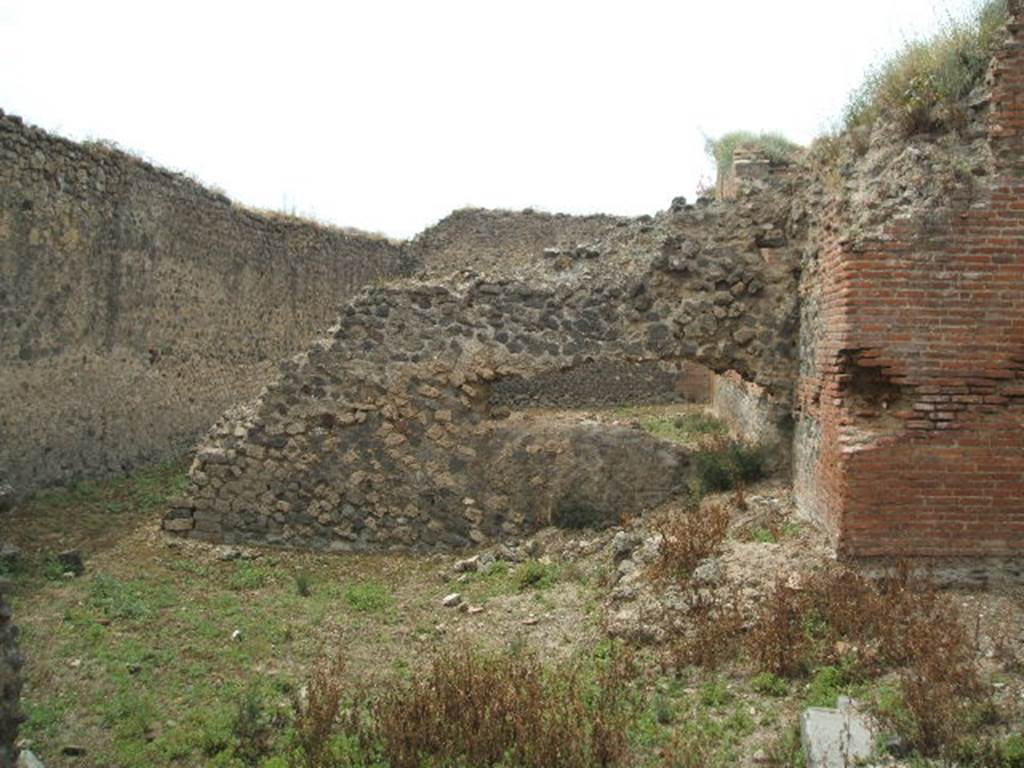 IX.4.15 Pompeii. May 2005. L shaped service area t with small garden. Looking west from entrance towards south-east corner of caldarium, and remains of garden wall. According to Jashemski, the five small windows of the caldarium looked out onto a small garden. The garden would have had a wall enclosing it, to hide from view the men walking back and forth tending the furnaces. The wall was only partially completed. See Jashemski, W. F., 1993. The Gardens of Pompeii, Volume II: Appendices. New York: Caratzas. (p.235).