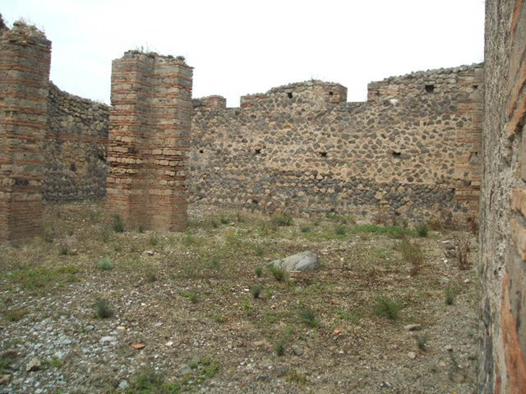 IX.4.16 Pompeii. May 2005. Looking north-west from entrance across open area u.
According to Mau
Between the rooms of the Baths and the eastern vicolo, there was only an area of open space, accessible by the two doorways from the eastern vicolo, and from which by a corridor you would pass into the vestibule [i].  
In the northern part are 3 pilasters of brick and limestone cut to look like masonry bricks, and it seems that they should have supported a roof  that in the guise of a portico would have covered the north side, and a part of the west side. 
See BdI, 1878, (p253 of pages 251- 254). 
