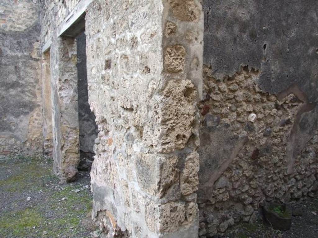 IX.5.2 Pompeii. December 2007. 
Looking south to doorways to rooms q and r on west side of peristyle, and corridor leading to IX.5.22 the rear entrance. 
According to Boyce, in the west wall of a room on the upper floor, above the first room on the west side of the peristyle, was a rectangular niche.
See Boyce G. K., 1937. Corpus of the Lararia of Pompeii. Rome: MAAR 14. (p. 85, no. 420) 
