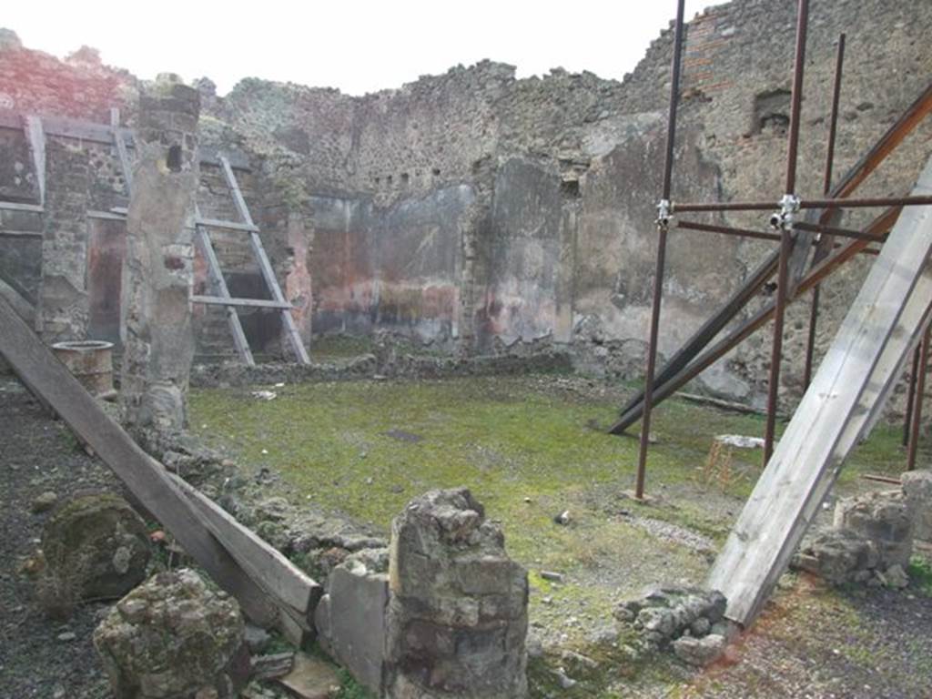 IX.5.9 Pompeii.  December 2007.   Room 10, looking south-west across peristyle towards room 13. According to Jashemski, this garden had a portico on the east, south and part of the north sides. It was supported by columns covered with yellow stucco, on which were painted garlands of leafy branches amidst which small birds were flying. The columns were connected by a low wall, today badly damaged. There was a large animal painting, only partially preserved upon excavation, on the west wall. See Jashemski, W. F., 1993. The Gardens of Pompeii, Volume II: Appendices. New York: Caratzas. (p.237 & No.94 on p.366)

