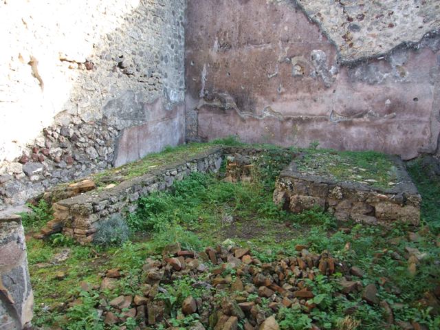 IX.5.11 Pompeii. December 2007. Room 15, garden area with triclinium, looking towards south-east corner.
According to Jashemski, the garden had a portico on the north and west.
This was supported by four columns painted black below, white above and joined by a low wall.
Most of the garden was occupied by a masonry triclinium.
Mau believed the extension, visible on the left of the photo, was a seat for children.
On the south garden wall was a large animal painting, totally destroyed.
See Jashemski, W. F., 1993. The Gardens of Pompeii, Volume II: Appendices. New York: Caratzas. (p.237, and no.95 on p.366)

