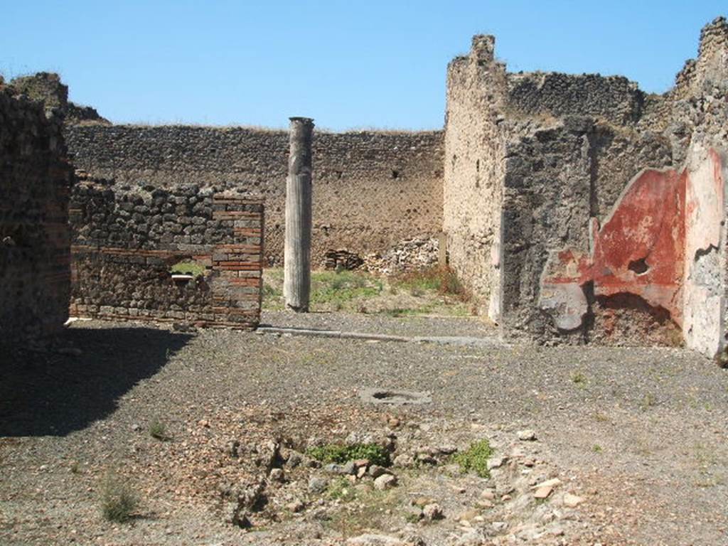 IX.5.14 Pompeii. May 2005. Looking west across impluvium in atrium towards the portico k.
On the right, the remains of the decorated walls in the north-west corner would have had a black zoccolo and middle zone with red panels.

