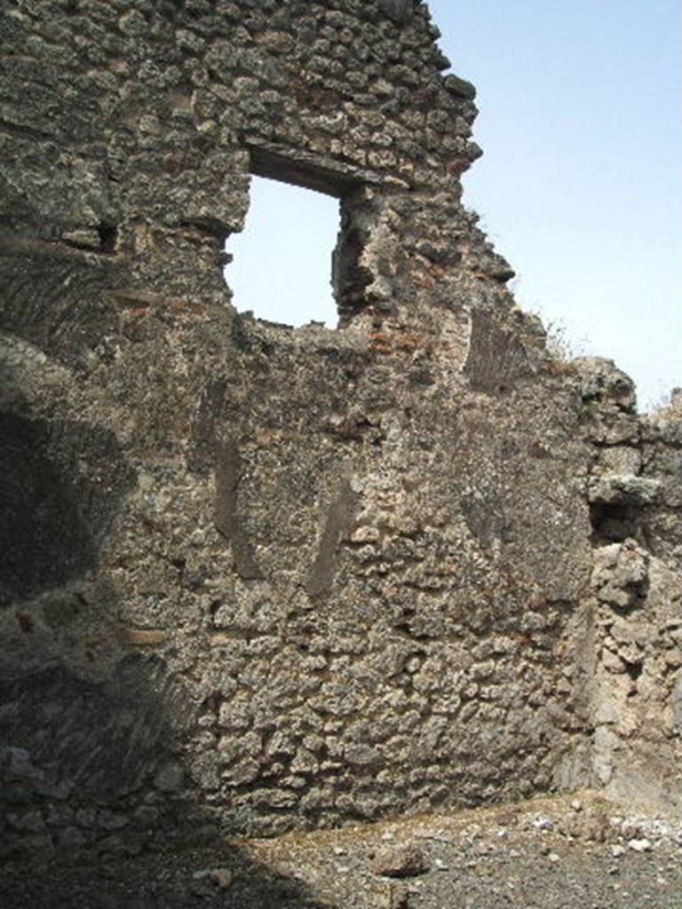 IX.6.3 Pompeii. May 2005. West wall of triclinium “a” to north of entrance.
This room had a window overlooking Vicolo di Tesmo. 
According to Mau, this room had a wooden threshold and a floor ornamented with irregular pieces of marble.
None of the wall decoration was preserved other than the rough plaster that was destined to be covered again with a finer layer.
This room may have been used to store various objects, as on 10th July 1879 various bronze and terracotta vases were found, together with the fragments of a saw, some bronze coins, etc. 
See Notizie degli Scavi di Antichità, 1879, p. 207.
See Mau in BdI, 1880, p. 217.

