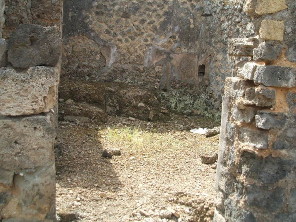 IX.6.3 Pompeii. May 2005. Doorway to kitchen area, looking south.
According to Boyce, on the east wall (not photographed) was a lararium painting, the upper part was damaged when found. An altar stood between the Genius on the right, and the tibicen on the left. On each side was a Lar with rhyton and situla standing between two shrubs. In the lower zone were two serpents confronted at an altar furnished with two eggs. See Boyce G. K., 1937. Corpus of the Lararia of Pompeii. Rome: MAAR 14. (p.86, no.428).  See Sogliano, A., 1879. Le pitture murali campane scoverte negli anni 1867-79. Napoli: (p.12, no. 25) According to Giacobello, today the painting has been totally lost.
See Giacobello, F., 2008. Larari Pompeiani: Iconografia e culto dei Lari in ambito domestico.  Milano: LED Edizioni. (p.209)

