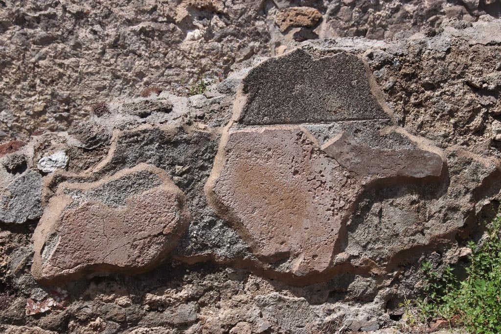 IX.6.7 Pompeii. May 2024. Detail of remaining plaster on north wall above hearth. Photo courtesy of Klaus Heese.