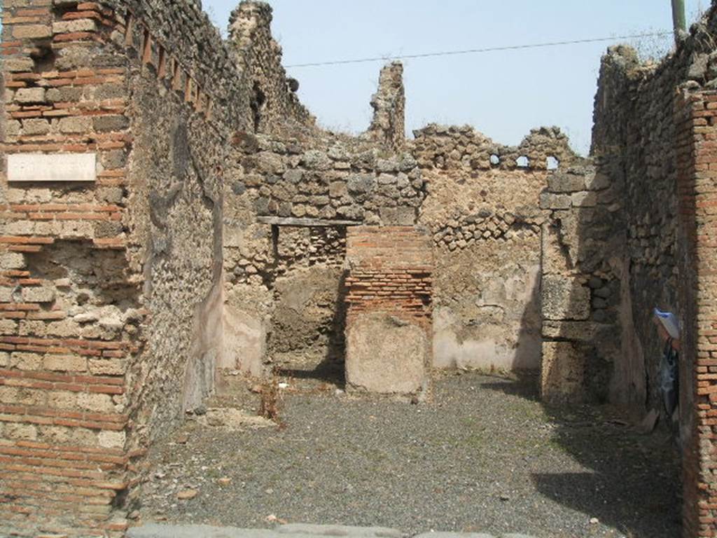 IX.6.a Pompeii. May 2005. Entrance doorway, looking north across large shop-room.
According to Eschebach, on the left was the hearth and steps to upper floor, with latrine beneath. See Eschebach, L., 1993. Gebudeverzeichnis und Stadtplan der antiken Stadt Pompeji. Kln: Bhlau. (p.428)
According to Flohr, see below, the stairs were in the rear room. This room identified as a shop or workshop had never been identified as a fullonica prior to his excavation in the north-west corner of the shop-room. The remains of the two low walls and a small platform, with space between the walls were thought to have been fulling stalls. Surface cleaning around the possible fulling installation confirmed the hypothesis.
See Rivista di Studi, XVIII, 2007, article by Flohr, M, entitled Cleaning the laundries report of the 2006 season, (p.134)
According to Mau, this was a shop with two rooms, one of them having a separate entrance from the western vicolo (IX.6.1). The shop and the room to the right had walls painted with a high flesh-coloured zoccolo (plinth); in the other room the plaster was not conserved.
See Mau in BdI 1881, (p.32), (described as number 14).
According to Varone, CIL IV 5203, 5204 and 5206 were found on the wall between IX.6.a and IX.6.b (see IX.6.b for details).
See also Mau in BdI 1881, (p.32)

