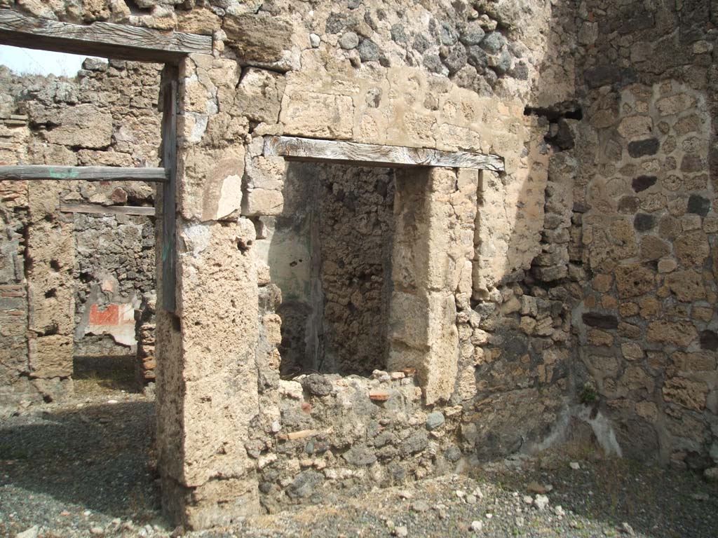 IX.6.e Pompeii. May 2005. North wall of shop, with door and window to IX.6.d.