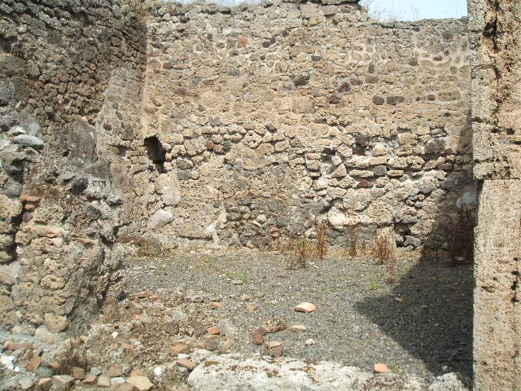 IX.6.f Pompeii. May 2005. Looking north across shop. According to Mau, this was described as number 9 of IX.6, and was a shop. In the corner to the left of the entrance was a cupboard (or small area), divided from the rest of the shop by a partition. On the walls of it  but not on the most recent road wall  were preserved remains of 1st style decoration: a red zoccolo (plinth), a little sunk in relation to the white surface of the upper wall.
See Mau in BdI, 1881, p.25
