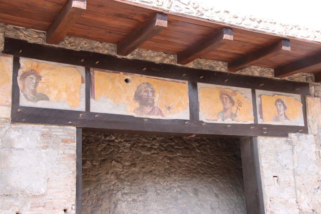 IX.7.1 Pompeii. September 2021.  
Paintings of four gods, (Apollo, Jupiter, Mercury und Diana), above entrance doorway. Photo courtesy of Klaus Heese.
