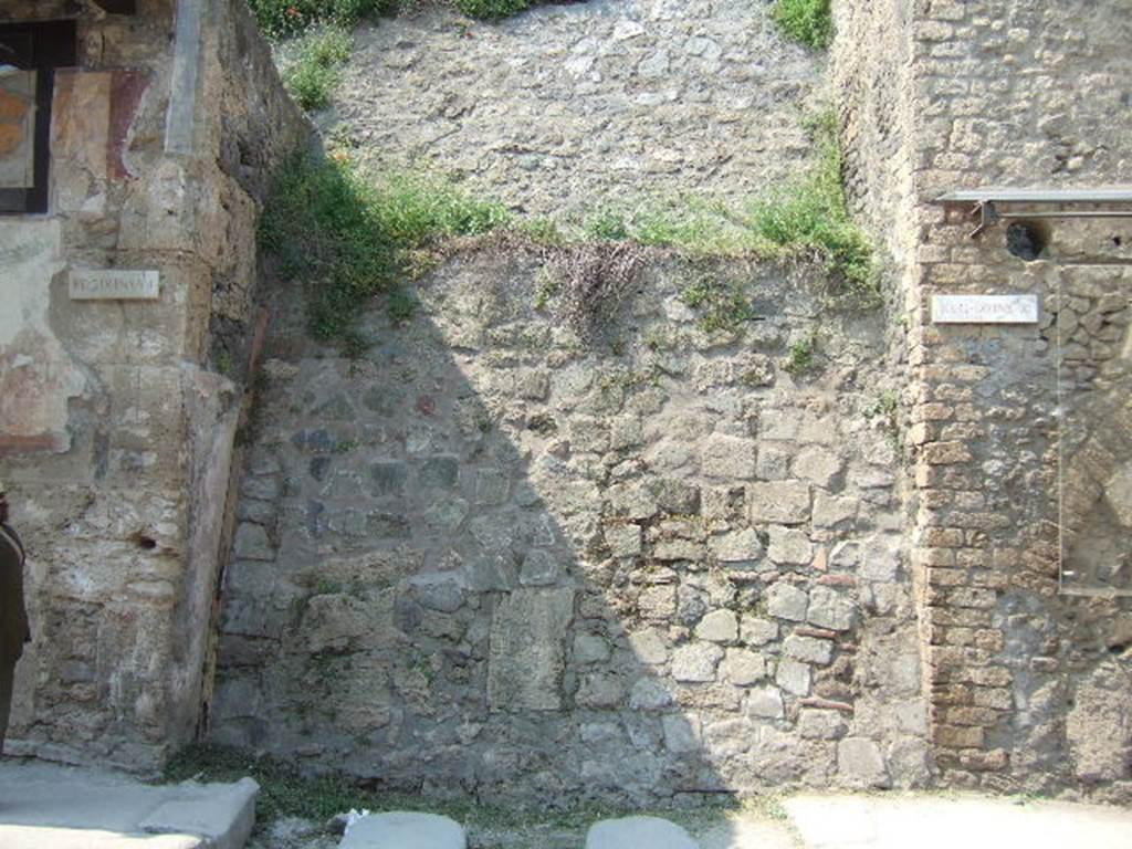 IX.7.1 Pompeii. May 2006. Unexcavated vicolo, looking north.   IX.11.
Found on the south-east corner of the insula IX.7, was a fragmentary list of magistrates from VICUS URBULANENSES, CIL IV 7807.  This was found on the east wall of IX.7.1, facing the small unexcavated vicolo. The graffito was not conserved.  Electoral notices mentioning the Urbulanenses all appear to have been found on the north side of Via della Abbondanza at III.4.1, III.4.3 and III.6.1.   Underneath CIL IV 7807, a graffito CIL IV 7808 was found.  According to Della Corte, found 11th February 1915 painted in black and red, an electoral register of Magistri Vici and Compiti of the pompeian Pagus Urbulanus. In the third and fourth line of the list, after the consular date, one reads in fact: (Pagi) Urbul(ani) / (Mag)(istri) Vici  [CIL IV 7807]  See Della Corte, M., 1965.  Case ed Abitanti di Pompei. Napoli: Fausto Fiorentino. (p.
See Varone, A. and Stefani, G., 2009. Titulorum Pictorum Pompeianorum, Rome: L’erma di Bretschneider, (p.382-3 with photo).
According to Epigraphik-Datenbank Clauss/Slaby (See www.manfredclauss.de), these read as –
o 
[3]o co(n)s(ulibus) 
[3] Urbul[anensis(?) 3] 
[3] vici [ // ]philus 
[3] L(ucio) Stabilio 
[3]pit [3]cili L(uci) ser(vi) 
[3]ini M(arci) ser(vi) 
[3]ari N(umeri) ser(vi)         [CIL IV 7807]

Cn(aeus)  Audium 
aed(ilem)  clientes  rogant        [CIL IV 7808] 
