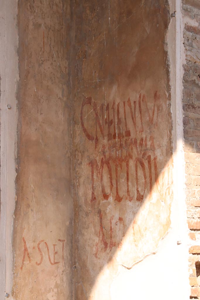 IX.7.5 Pompeii. October 2023. 
Graffiti outside workshop of Verecundus on east side of doorway. Photo courtesy of Klaus Heese.
