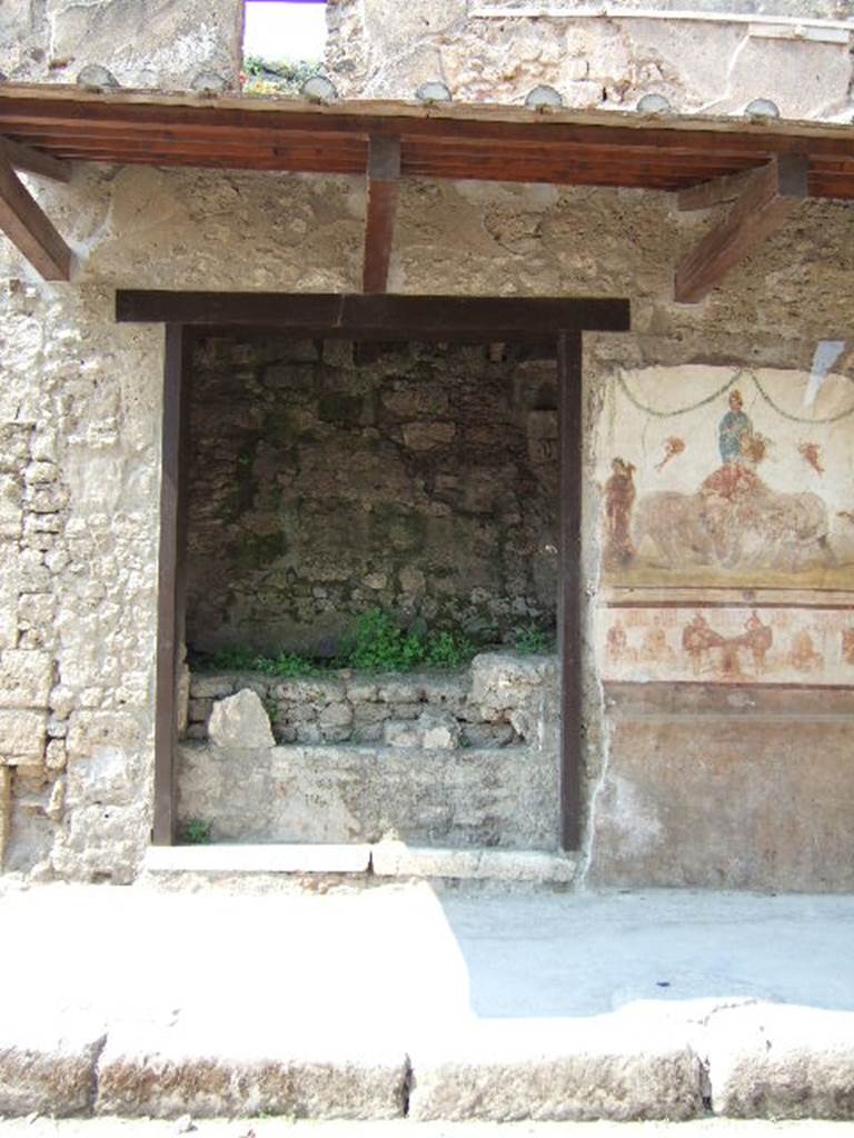 IX.7.7 Pompeii. May 2006. Entrance on Via dell’Abbondanza. Upon excavation, a plaster-cast of the door was made showing the horizontal long bolt made of iron. Part of this plaster-cast can still be seen in the doorway, although it has deteriorated with age.
On the left of the doorway was a painting of Mercury with inscriptions above, and another painting below. The paintings have now been detached from the wall and are held in the storerooms together with CIL IV 7841 and 7842. (inventory number 40685.  Found on the lower painting, from the pilaster on the left of the doorway, were inscriptions CIL IV 7843 and 7844.  These have now almost vanished.  
See Varone, A. and Stefani, G., 2009. Titulorum Pictorum Pompeianorum, Rome: L’erma di Bretschneider, (p.407-411)

