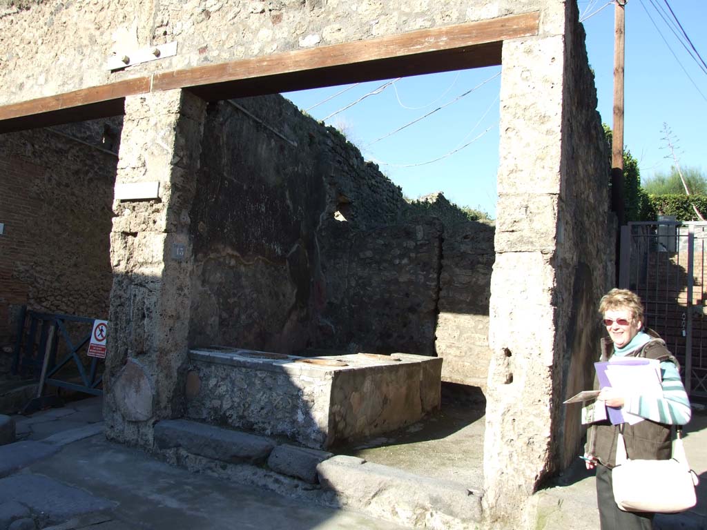 IX.7.13 Pompeii. December 2006. Looking north-west towards entrance on north side of Via dell’Abbondanza.
(NOTE: the stairs leading up to the Casina dell’Aquila, above IX.7.12, on right).
