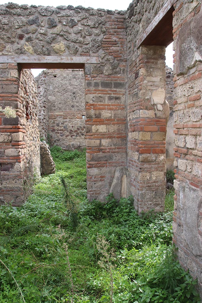 IX.7.16 Pompeii. October 2024. 
Looking towards south-west corner of atrium 2, with doorway to room 3, on left, and into room “b”, on right. Photo courtesy of Klaus Heese.
