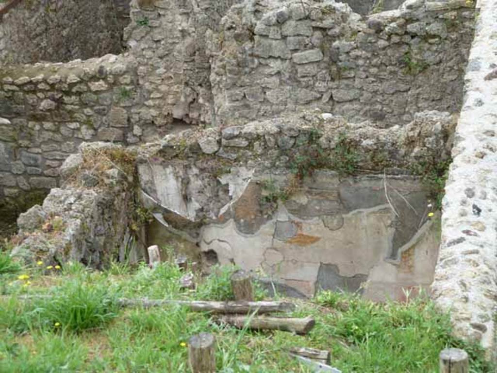 IX.7.16 Pompeii. May 2010. Cubiculum “c”, looking towards west wall.
Looking towards the west wall of room “c” with the remains of painted plaster, on the south side of the atrium.
According to Schefold, on the west wall a painting of Mars and Venus was found. (Helbig 323)
A drawing of the painting can be seen in Schefold, K., 1962. Vergessenes Pompeji. Bern: Francke. (fig.55, 3)
On the east wall, a drawing of the painting of Achilles receiving the arms can be seen in fig.55, 4.
On the south wall, on the left of the photo, a fragment of the wall painting of Cassandra, Hector, was found.
See Schefold, K., 1957. Die Wande Pompejis. Berlin: De Gruyter. 

According to Mau, “The walls were of the same character as those in the triclinium and the other cubiculum.
The walls were simply decorated in the III style.
The zoccolo was painted with a black background, the middle of the wall was red, and the upper part was white.
The execution of the decoration was considered inferior, by Mau, to that of the other cubiculum.
In the middle of each wall was a painting in the usual painted pavilion.
- on the left (east) wall – the design showed the interior of a house with a column on the left middle of the painting, a second column was on the right, garlands were hanging on them. In front of this last, a little more to the left, was a young person with heroic stature, with a red cloak (......) In his right hand was a golden helmet. More to the right was a woman (...) Another woman stood beside the base (......) They all looked towards the helmet.
- on the rear wall (south) only a fragment remained: towards the right edge was a figure: the one here had a lance in his right hand (see also Sogliano 560, thought to be Hector) and Helbig 1381, 1391b)
- on the left (west) wall was a painting of Mars and Venus”.
See Mau, in Bullettino dell’Instituto di Corrispondenza Archeologica (DAIR), 1883, (p. 131-133).


 


