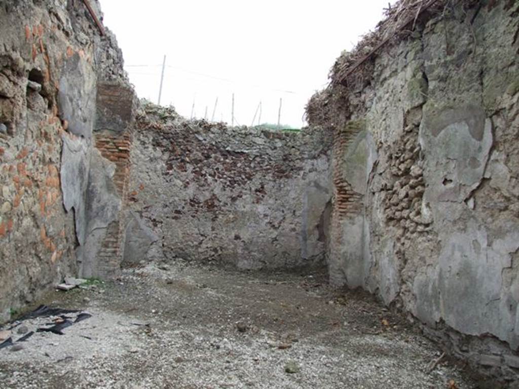 IX.7.18 Pompeii. December 2007. Looking east across shop towards rear room. According to Eschebach, on the left would have been the stairs to the upper floor. A doorway in the rear room would have led into the atrium of IX.7.19.  See Eschebach, L., 1993. Gebudeverzeichnis und Stadtplan der antiken Stadt Pompeji. Kln: Bhlau. (p.434)