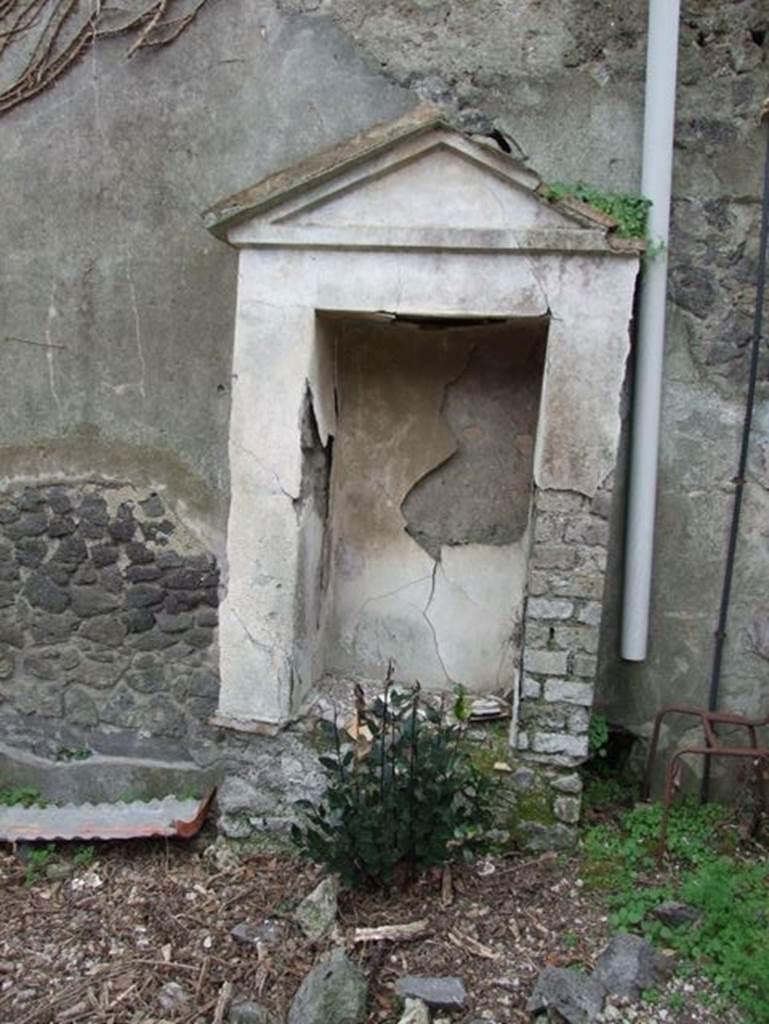 IX.7.20 Pompeii. December 2007. Aedicula with niche on north side of fountain, looking west.
According to Boyce -
When excavated this one, found on the north side (to the right) contained the following terracotta statues –
Asclepius with snake, Bacchus with a leopard, a clothed woman holding a bird, and fragments of a fourth – perhaps Minerva.
Also found was a small terracotta bird resembling a dove on a cylindrical base.
See Boyce G. K., 1937. Corpus of the Lararia of Pompeii. Rome: MAAR 14. (p. 89, no.446) 
See Jashemski, W. F., 1993. The Gardens of Pompeii, Volume II: Appendices. New York: Caratzas. (p.242-3, no.504, location given as IX.7.25).

