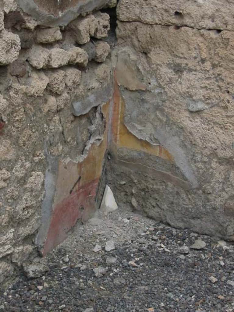 IX.7.22 Pompeii. May 2003.  Remains of painted plaster in the room on east side of caupona. Photo courtesy of Nicolas Monteix.
