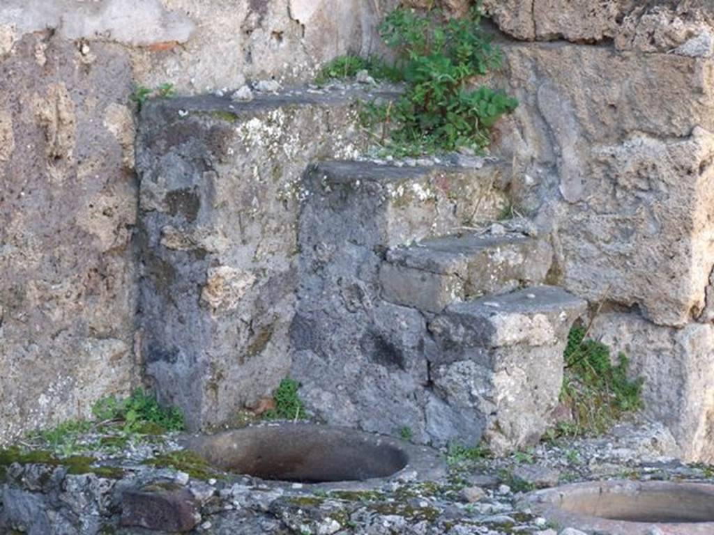 IX.9.1 Pompeii.  March 2009. Shelving for displaying crockery and other items, as well as two dolia set in counter for food and drinks.