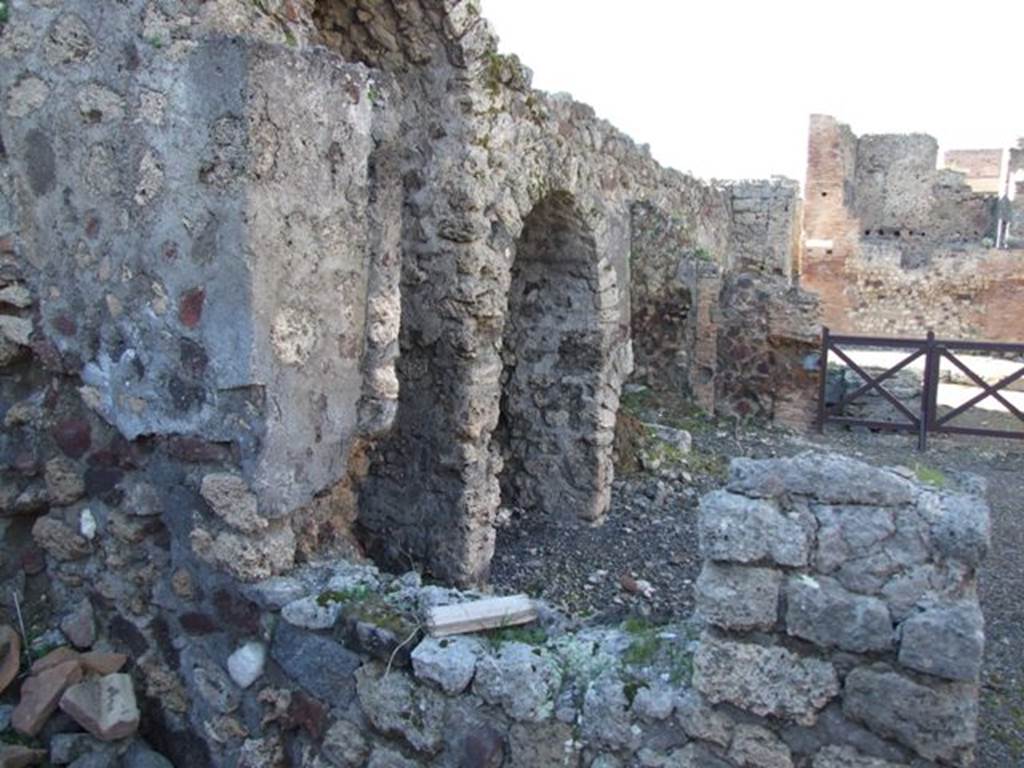 IX.9.2 Pompeii. March 2009.  Looking north from cubiculum “d” through window into atrium with stairs to upper floor, and 3 arched recesses underneath.
