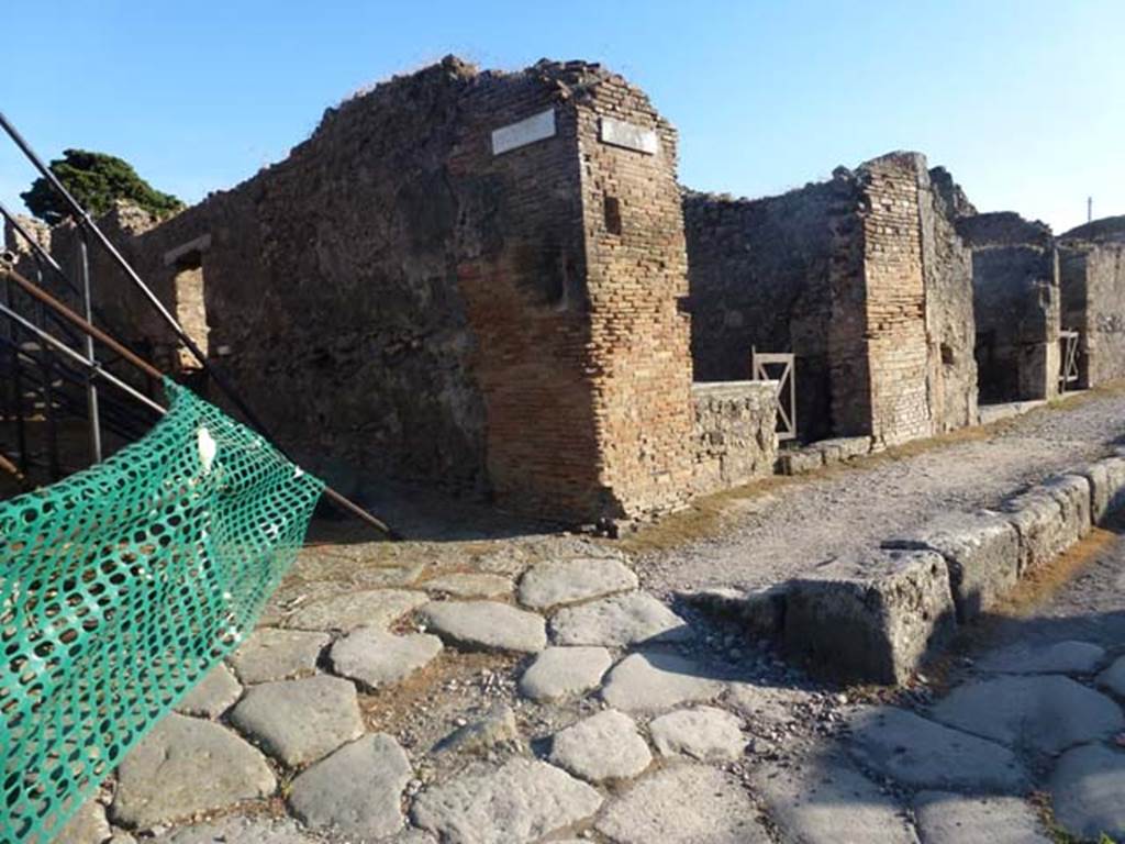 IX.9.8 Pompeii. June 2012. Looking south-west towards side wall, with entrance at IX.9.8 in the centre right. On the left behind the green plastic tape, the rear side entrance at IX.9.9 can be seen. Photo courtesy of Michael Binns.
