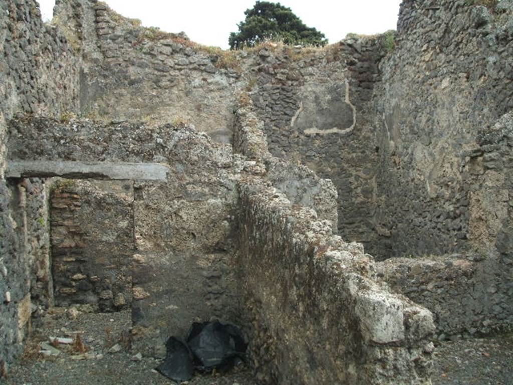 IX.9.9 Pompeii. May 2005. Looking south from corridor, towards doorway to light-yard (seen on upper right side). Through the doorway on the left, was an open courtyard garden area at the south of the corridor. At the rear of the doorway (on upper left-side) would be another room with a doorway from the open courtyard and with window into the courtyard on its west side. According to Eschebach, on the right was a kitchen with a window to the light-yard. At the rear was a windowed triclinium, and a courtyard garden.
See Eschebach, L., 1993. Gebudeverzeichnis und Stadtplan der antiken Stadt Pompeji. Kln: Bhlau. (p.442)
According to NdS, the room on the right would have been a narrow storeroom. The room in the upper left-rear side was a mystery room (stanza mistica) with a projecting window into the courtyard. In the courtyard was the doorway to the mystery room, on its external wall was seen the remains of a painting of a large serpent. In its north-west corner, and bricked into the pilaster, was a terracotta tub or basin ?
See Notizie degli Scavi, 1889, p.526

