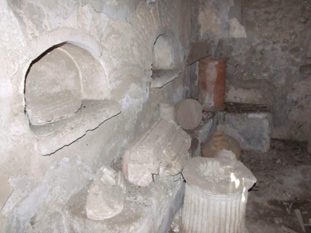 IX.9.10 Pompeii.  March 2009.  North wall, 2 arched niches, and below them, a masonry bench built along the north wall and part of the east wall.