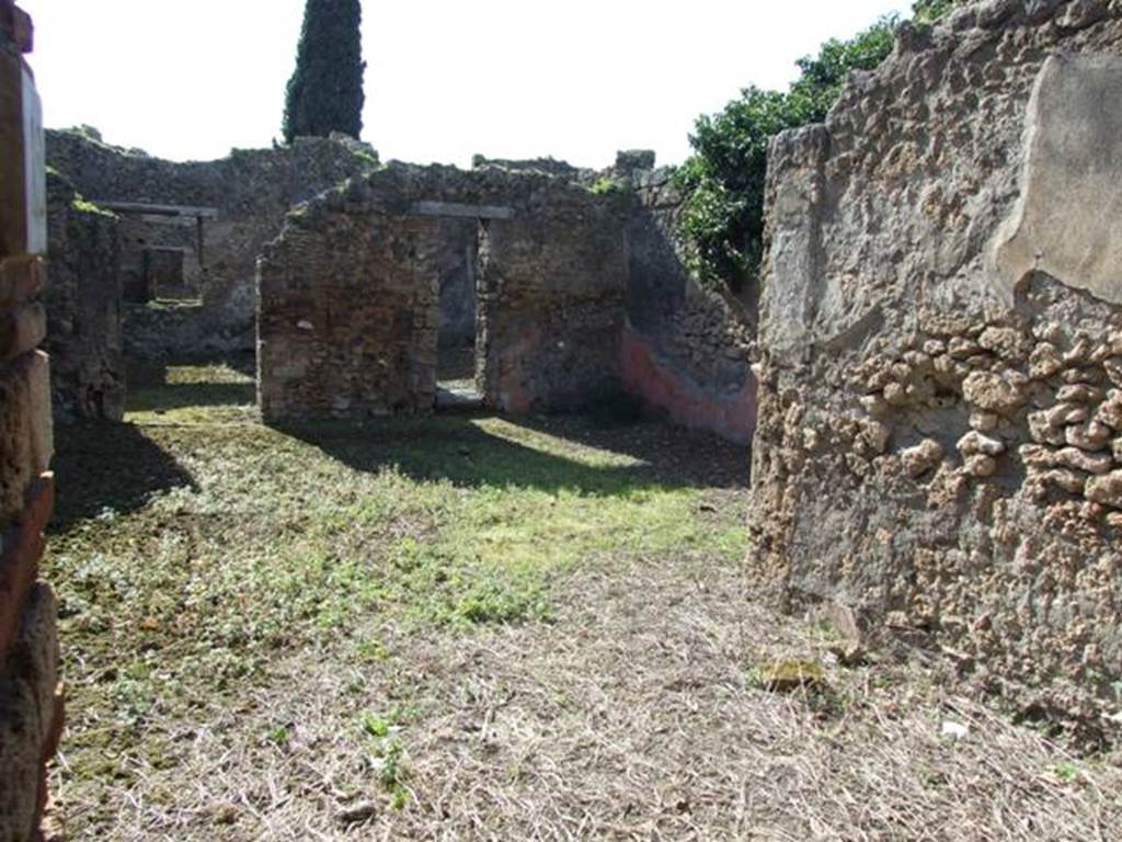 IX.9.12 Pompeii. March 2009. Looking west across room 11, from entrance doorway.
According to NdS, the entrance doorway was rather wide and it had a lava threshold. When excavated, a big iron hinge was still fixed into the threshold.  The floor was of signinum, and much remained of the wall decoration which consisted of rustic plaster and high red zoccolo.
On the left of the entrance was the doorway to the stables, (our room 12) and on the right was a doorway to a cubiculum (our room 14).
See Notizie degli Scavi, 1891, p.256.
