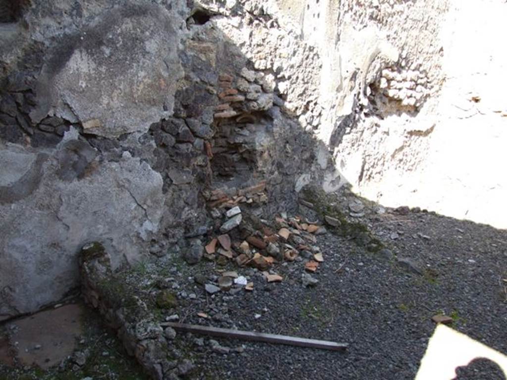 IX.9.12 Pompeii. March 2009. Room 15, north wall of kitchen.  On the left of the photo would be the area for the small impluvium. In the centre would be the area where the latrine was found. On the right would have been the hearth area. When it was discovered, the floor of the hearth was destroyed.
See Notizie degli Scavi, 1891, (p.256)
