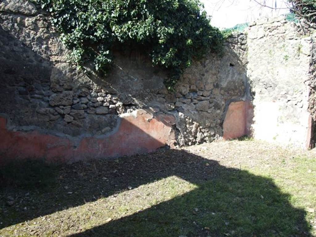 IX.9.12 Pompeii. March 2009. Looking north-east across room 11, the atrium area. The remains of the high red zoccolo (dado) can still be seen.
