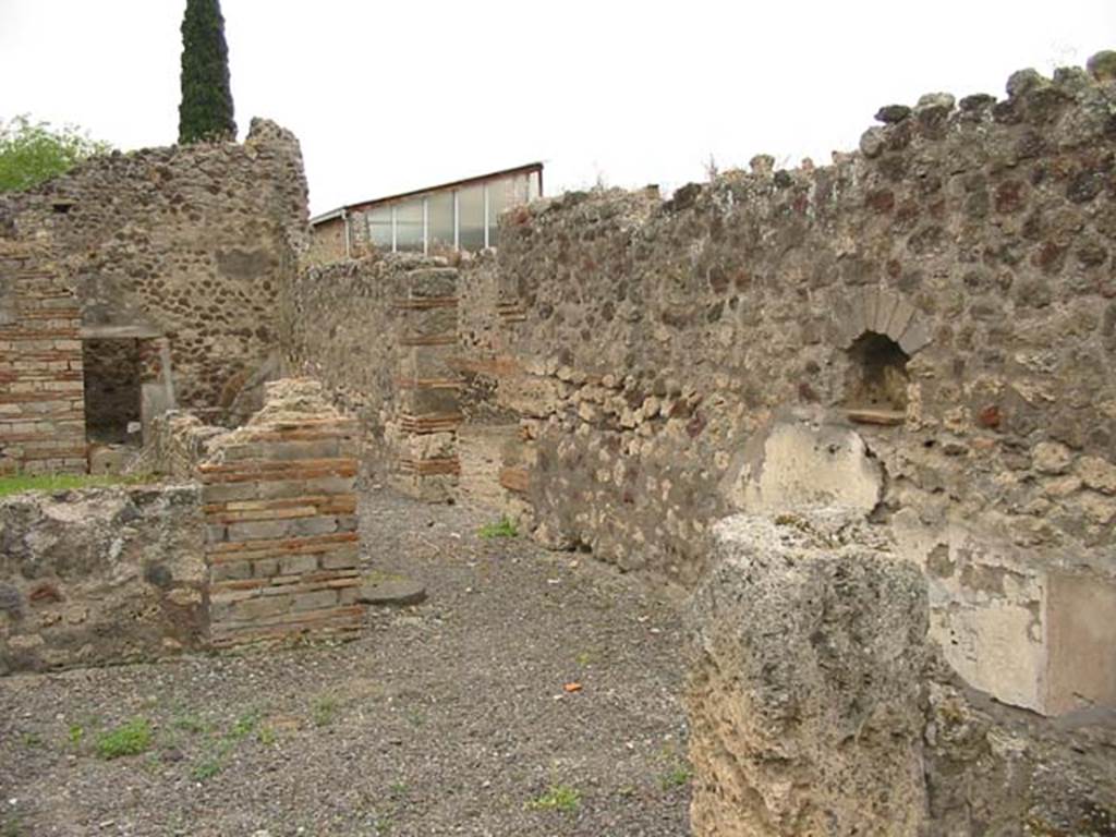 IX.9.a Pompeii. May 2003. Looking south-west across wide north portico, towards west wall and niche. Photo courtesy of Nicolas Monteix.