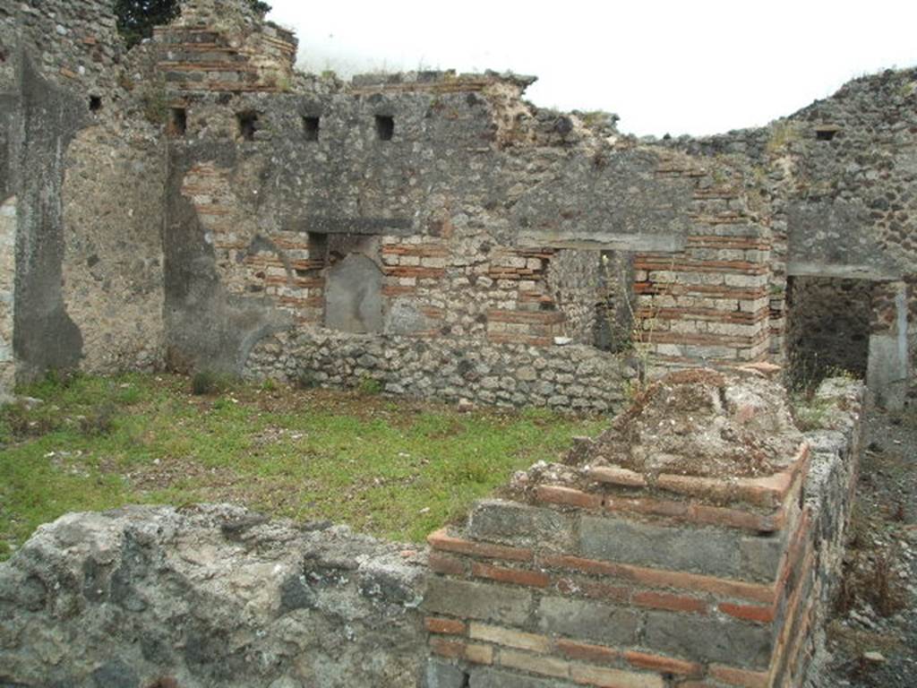 IX.9.a Pompeii. May 2005. Looking south across room f, garden from north-west corner.
According to NdS, the peristyle f was surrounded by a portico on two sides, the north and west. The portico was supported by plastered brick pilasters, and by one tufa column in the south-west corner. The pilasters were connected by means of a wall between them, and at the base was a channel for rainwater. See Notizie degli Scavi, 1888, p.515.
