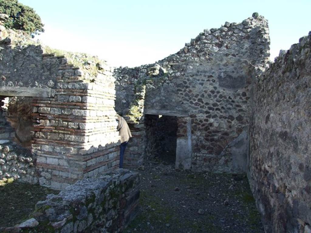 IX.9.a Pompeii.  March 2009.  Looking south along wide passageway to Kitchen and Latrine in south west corner.