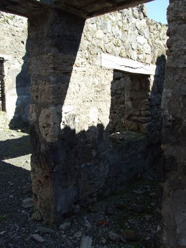 IX.9.e Pompeii. March 2009. Doorway to room 18, cubiculum. Looking towards the east wall with window onto room 17, small atrium. On the left is the doorway into room 17.
According to NdS, the walls of the cubiculum were decorated in the same way as the entrance corridor, and traces of fire and burning were found on them. It was clearly a cubiculum as could be seen by the grooves for the bed.
See Notizie degli Scavi, 1891, p.255.
