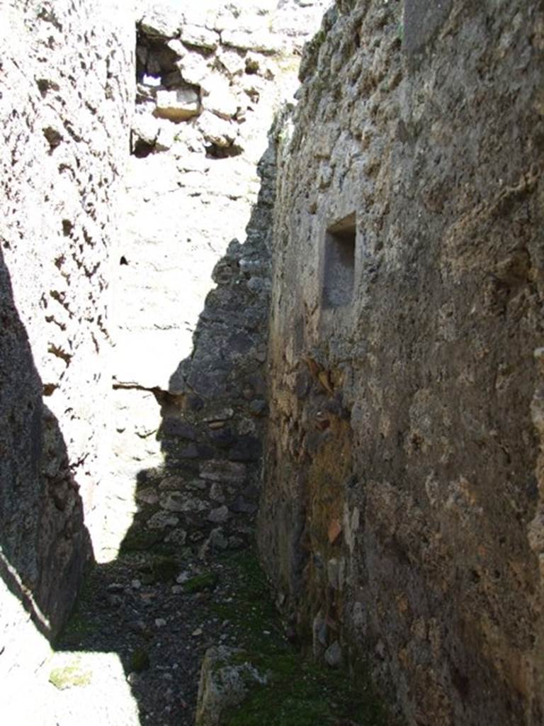 IX.9.f Pompeii. March 2009. Looking east along south wall of small room, with site of staircase and latrine. 
