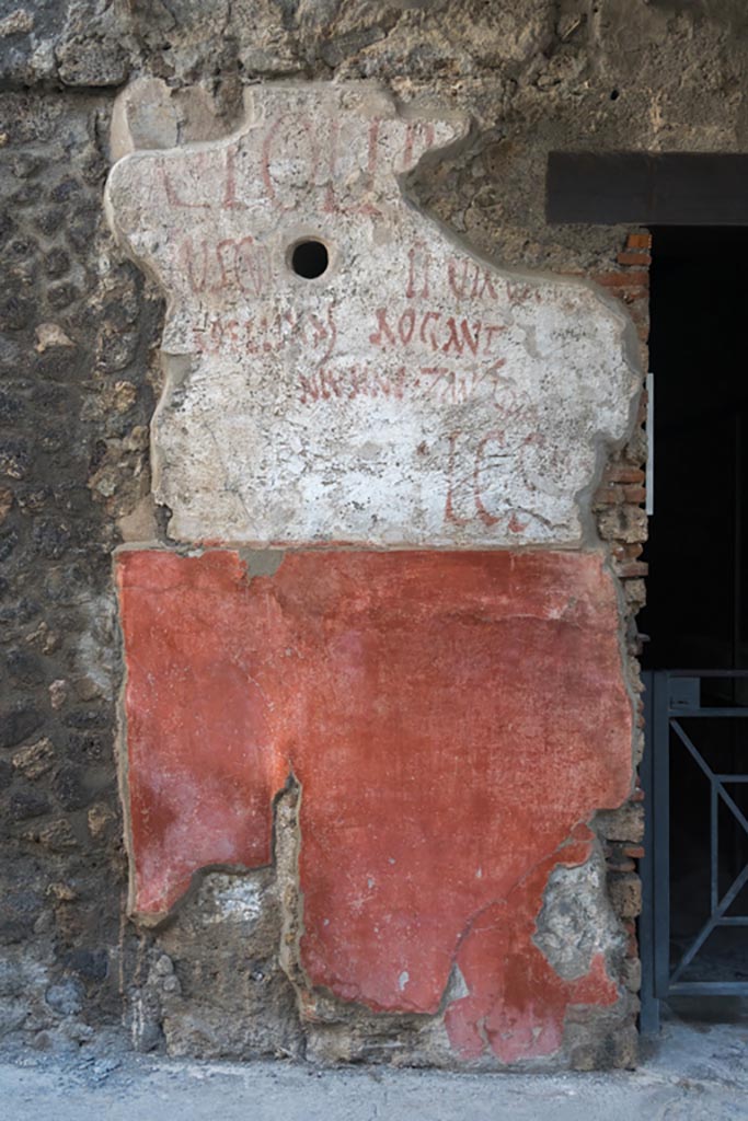 IX.11.2 Pompeii. October 2023. Graffiti on west side of doorway. Photo courtesy of Johannes Eber.