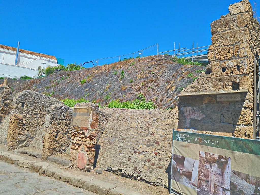 IX.11.6/7 and 8 (in centre), on north side of Via dell’Abbondanza. June 2024. 
Looking north-west towards entrance doorways. Photo courtesy of Giuseppe Ciaramella.
