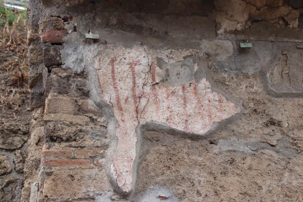 IX.11.8 Pompeii. May 2024.  
Detail of remaining graffiti on front wall, east of doorway, at east end of insula. Photo courtesy of Klaus Heese.
