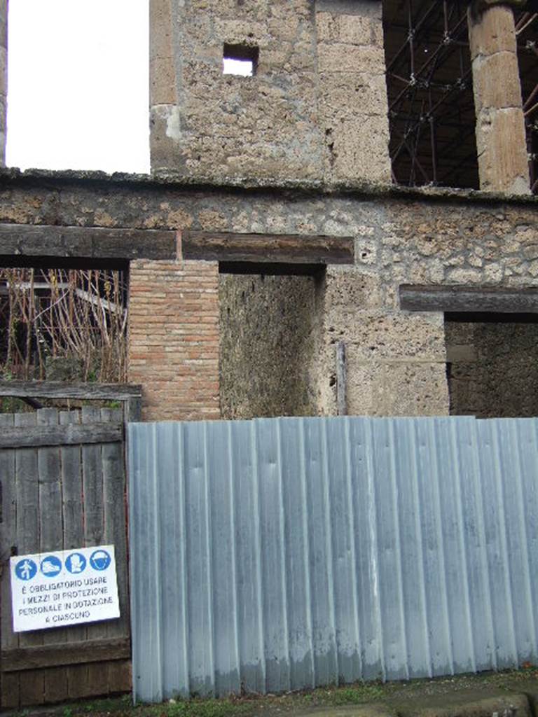 IX.12.2 Pompeii. December 2005. Entrance, leading to stairs to upper floor. According to Boyce, on the south side (front) pilaster, visible on the right of the photo, was a painting of Mercury. This was on the pilaster to the right of the entrance to the stairs leading from the street to the upper floor. Mercury was shown with a serpent at his feet coiled around an omphalos; the painting on the opposite pilaster had disappeared.  Not. Scavi, 1912, 144f.  See Boyce G. K., 1937. Corpus of the Lararia of Pompeii. Rome: MAAR 14. (p.112, no.27)  See Frhlich, T., 1991. Lararien und Fassadenbilder in den Vesuvstdten. Mainz: von Zabern. (F69)
According to Varone and Stefani, found on the pilaster, on the left, between IX.12.1 and IX.12.2 were CIL IV 7896 and 7897. On the right of the doorway, also found were CIL IV 7898, 7900 and 7903. In the photo on page 443, a plaster-cast of the stairs in situ was made, and can be seen. See Varone, A. and Stefani, G., 2009. Titulorum Pictorum Pompeianorum, Rome: Lerma di Bretschneider, (p.441-449)
According to Epigraphik-Datenbank Clauss/Slaby (See www.manfredclauss.de), these read as 
Ampliatum 
aed(ilem)         [CIL IV 7896] 
Vettiu[m 3]       [CIL IV 7897]
Valentem 
filium  aed(ilem)  o(ro)  v(os)  f(aciatis)       [CIL IV 7898]
Pansam  aed(ilem) 
Amandus  sacerdos  rog(at)         [CIL IV 7900]
Balbum  aed(ilem)  d(ignum)  r(ei)  p(ublicae) 
[3]fus  facit       [CIL IV 7903]
According to Della Corte, he thought this was a textrina, of an unknown Rufus, who was mentioned in an electoral recommendation. This was CIL IV 7903, found on the pilaster to the right of the stairs. Not least interesting were the plaster-casts of the stairs, of the wall and door of the latrine, and of the entrance door to a room to the north. All plaster-casts that were destroyed in the bombing. See Della Corte, M., 1965.  Case ed Abitanti di Pompei. Napoli: Fausto Fiorentino. (p. 321-2)
