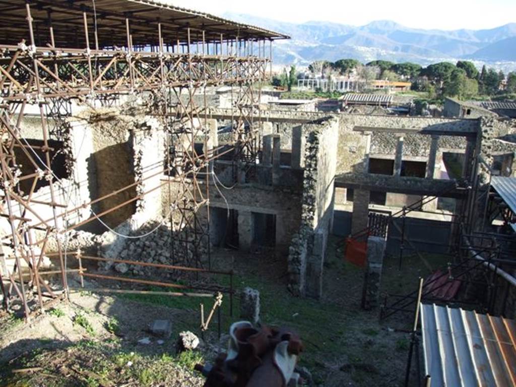 IX.12.5, IX.12.4, IX.12.3 and IX.12.2 and IX.12.1 Pompeii.  March 2009. Looking south from rear.