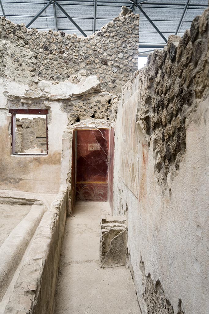 IX.12.6 Pompeii. July 2024.
Room “n1”, looking south along west wall with lararium painting above the altar.
Photo courtesy of Johannes Eber.

