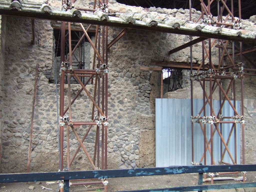 IX.12.6 Pompeii. December 2005. West (left) side of entrance doorway (behind blue metal).