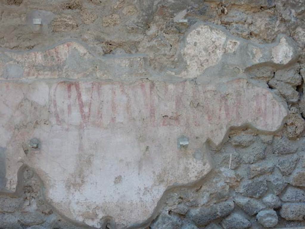 IX.12.7 Pompeii. May 2017. Detail of remaining graffiti on east side of panel, below window opening between IX.12.6 and IX.12.7.  Photo courtesy of Buzz Ferebee.

