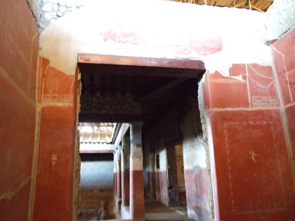 IX.12.9 Pompeii. March 2009. Room 14, west wall of cubiculum, with doorway  looking west across north side of peristyle.